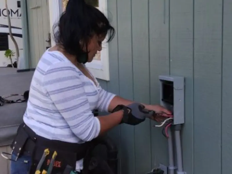 Licensed electrician wiring an exterior subpanel in Whiteman AFB