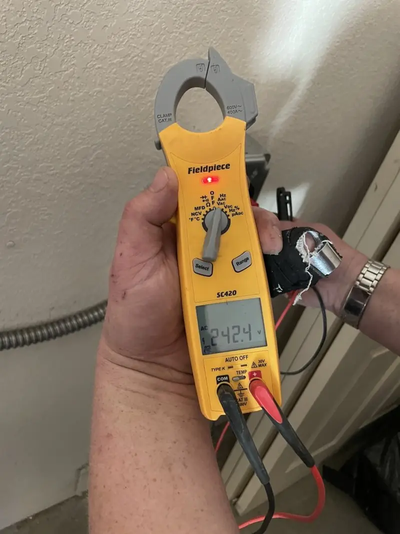 Voltage testing with clamp meter during Aluminum Wiring Replacement in Whiteman AFB